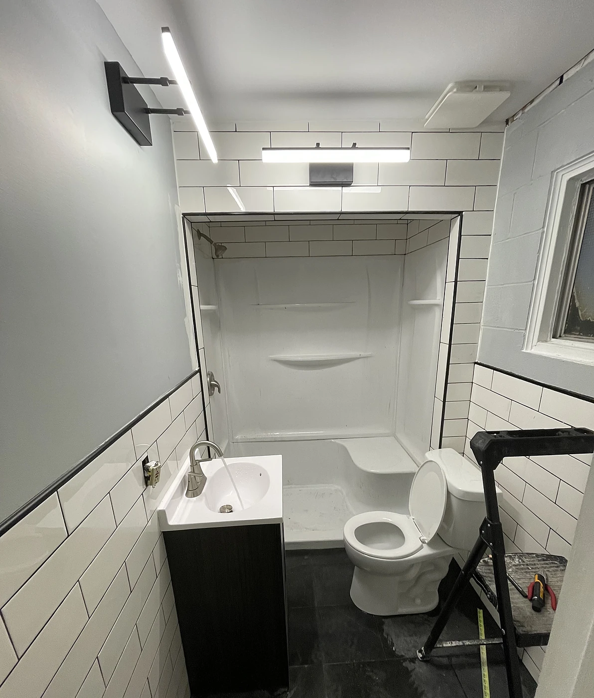 Remodeled bathroom with subway tile, new tub and vanity