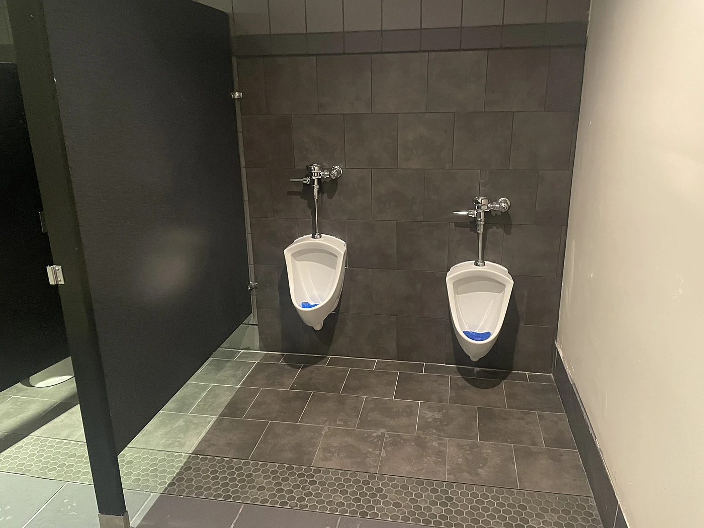 Finished commercial restroom with completed tile and fixtures