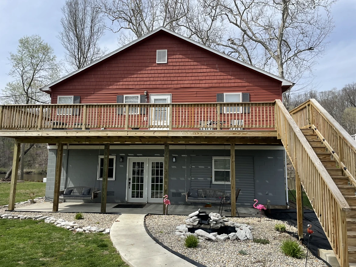 Home before full exterior renovation, original siding with new deck