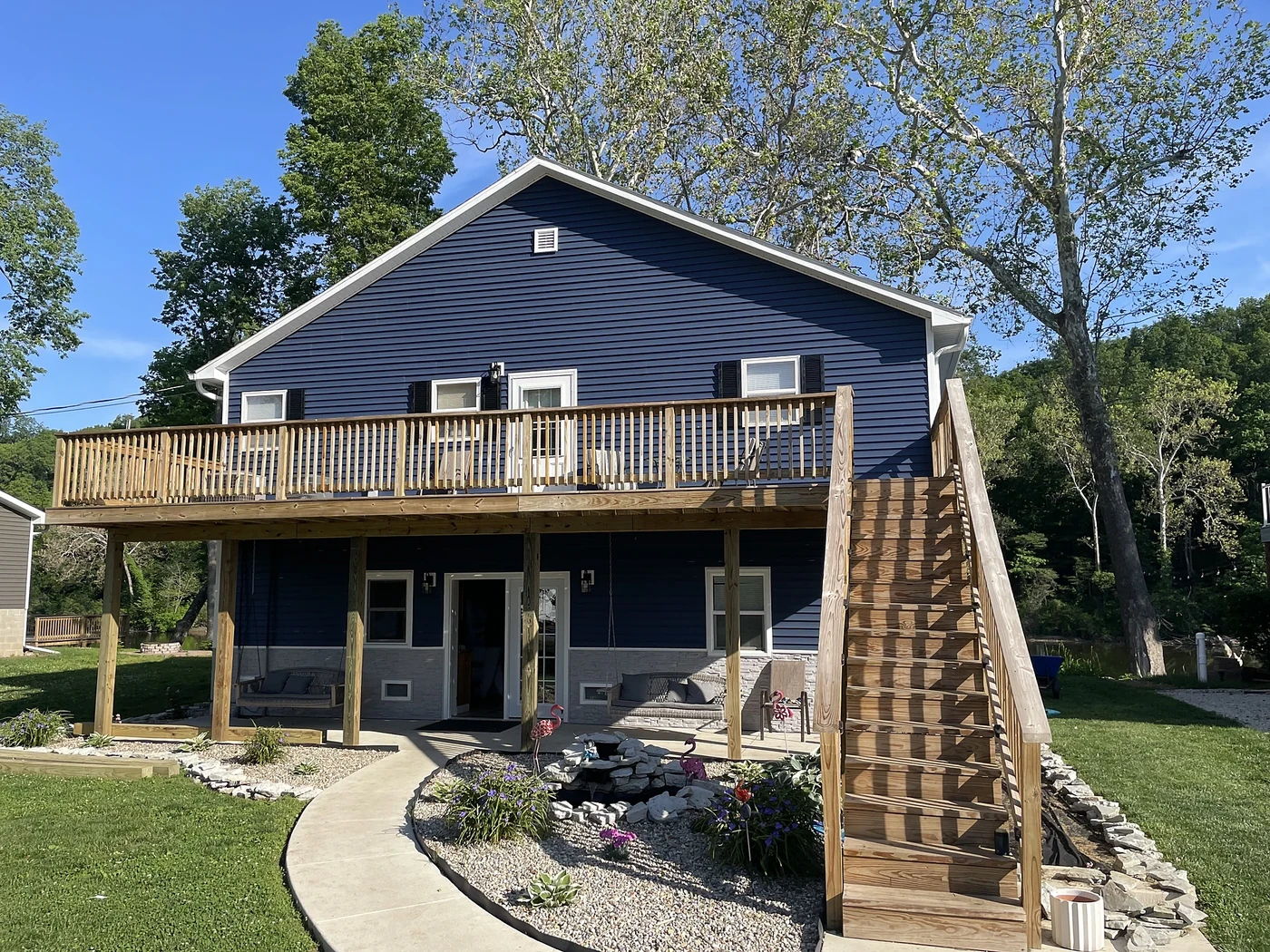 Fully renovated blue home with new siding and completed deck