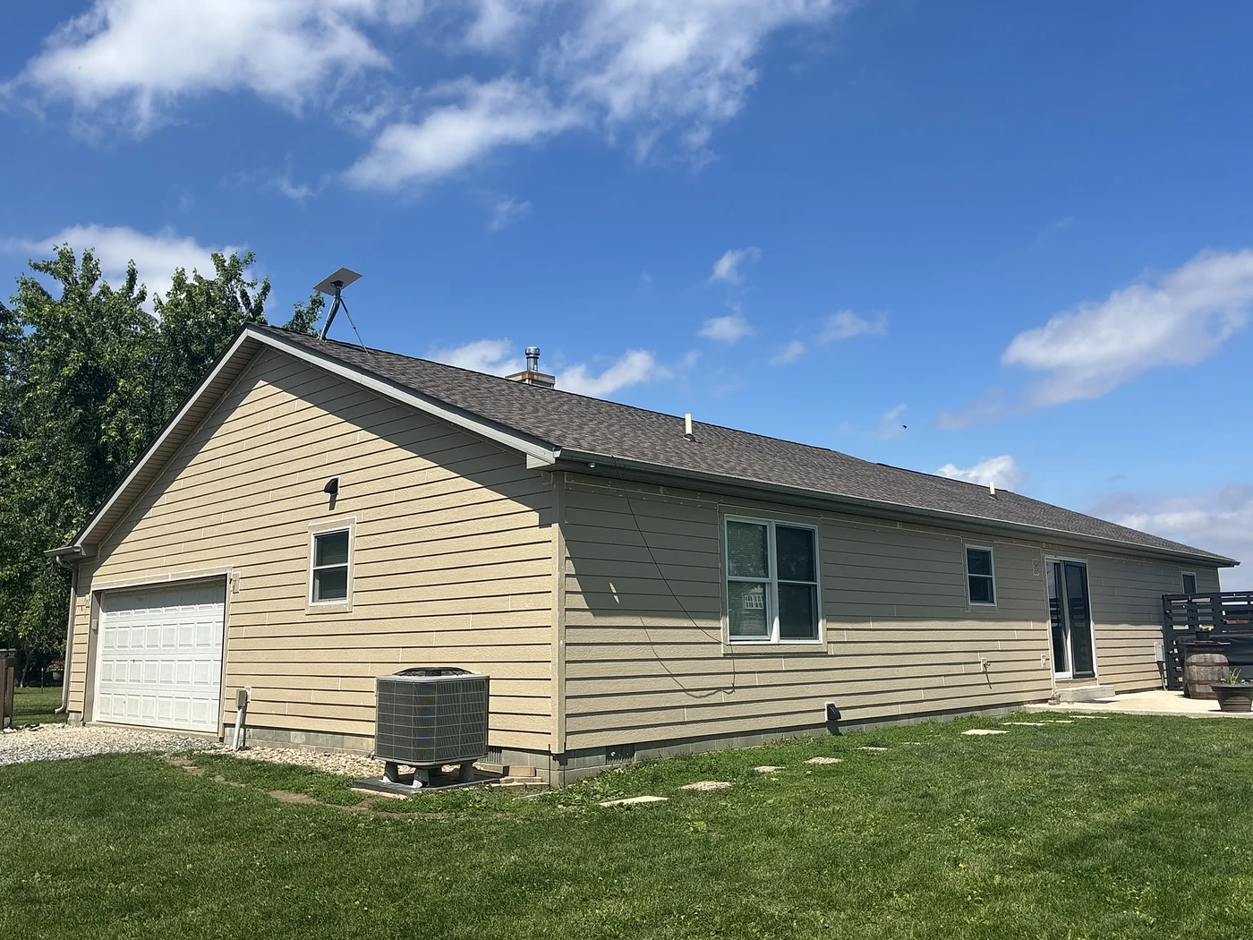 Home exterior with new tan siding completed